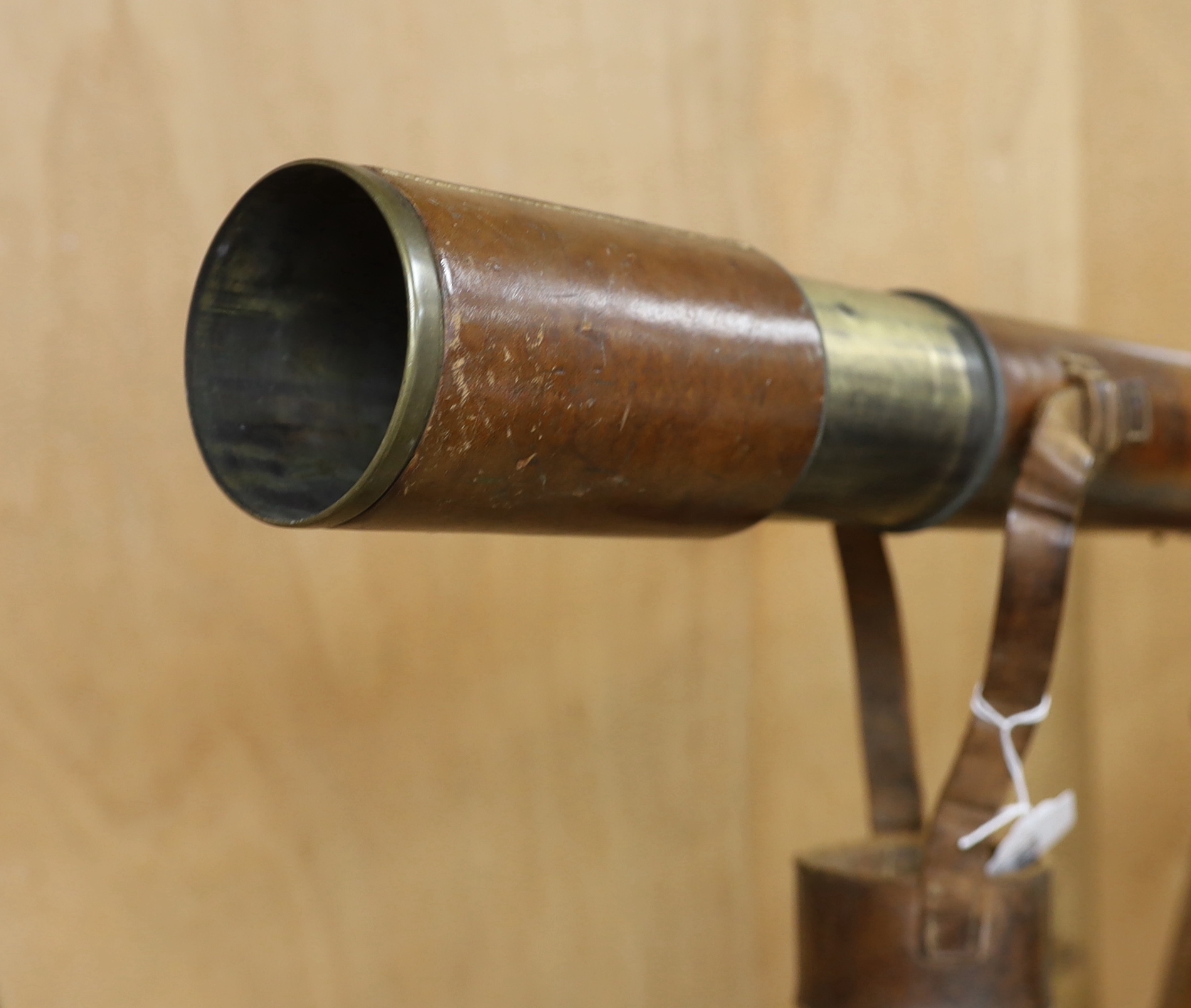 A WWI leather cased telescope and tripod, 57cm